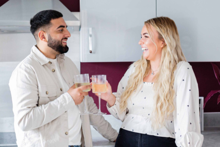 Family laughing in kitchen.