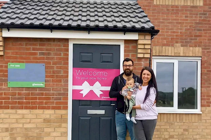 Couple and baby at front door