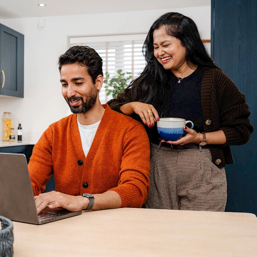 Couple looking at laptop in the kitchen