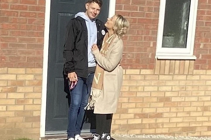 Gleeson homeowners stood at front door smiling