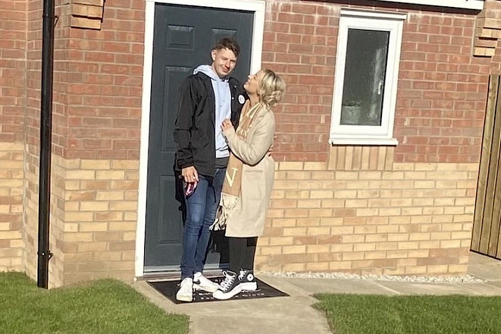 Gleeson homeowners stood at front door smiling