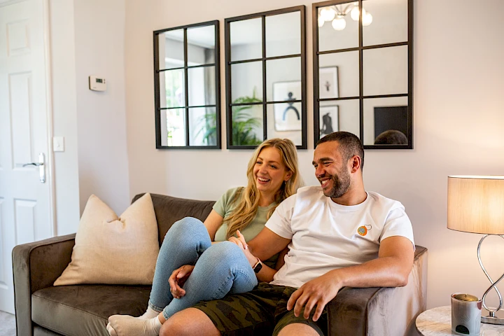 Young couple on the sofa in the living room of their home