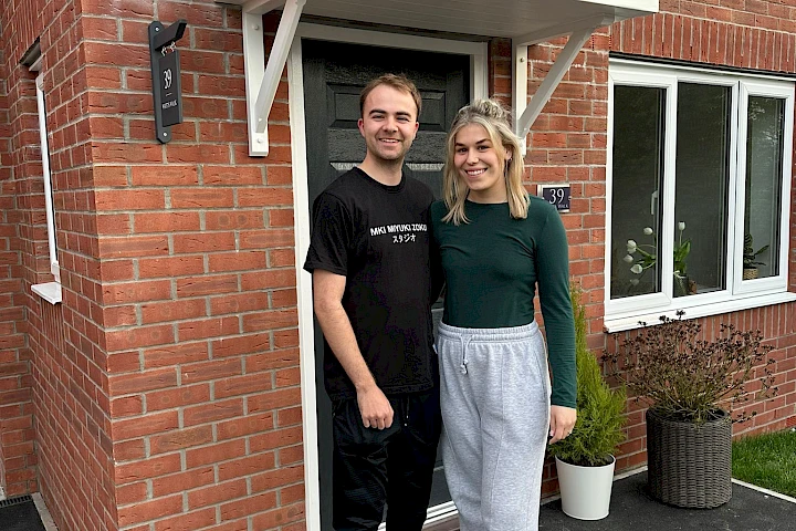 Customers in front of their home smiling