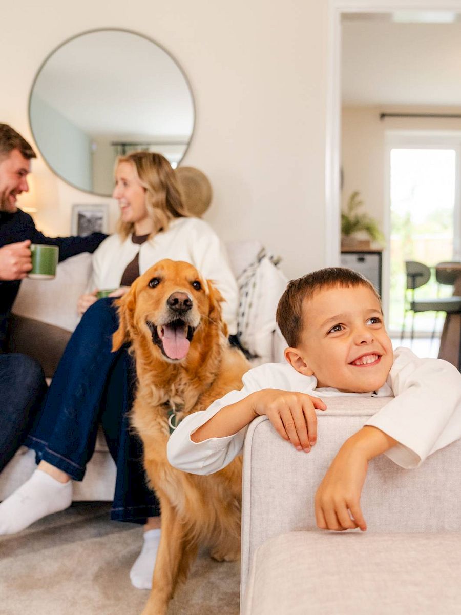 Young boy with smiling dog in living room