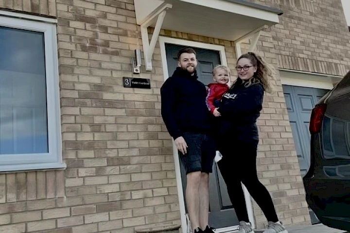 family at the front of their home
