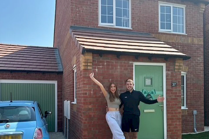 Couple at the front of their house