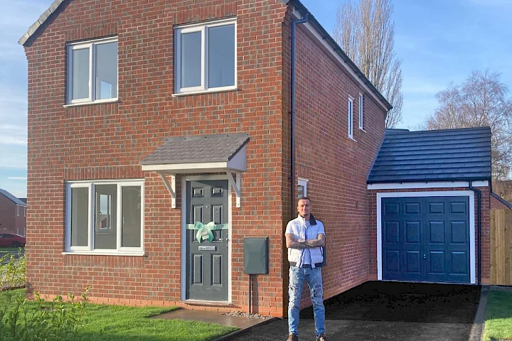 Solo male homeowner at the front of his home