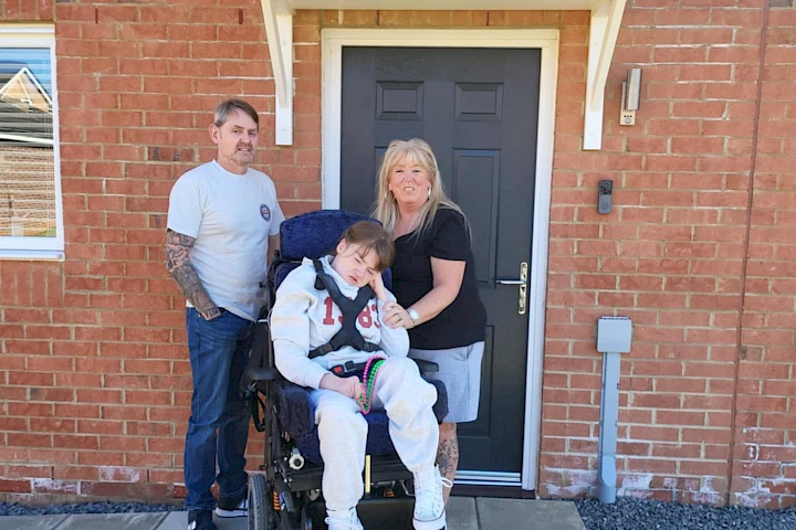 Family pictured outside of their home