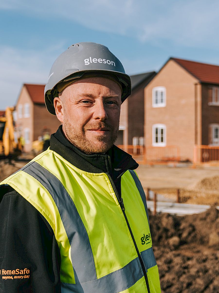 Man in hard hat and hi-vis on construction site