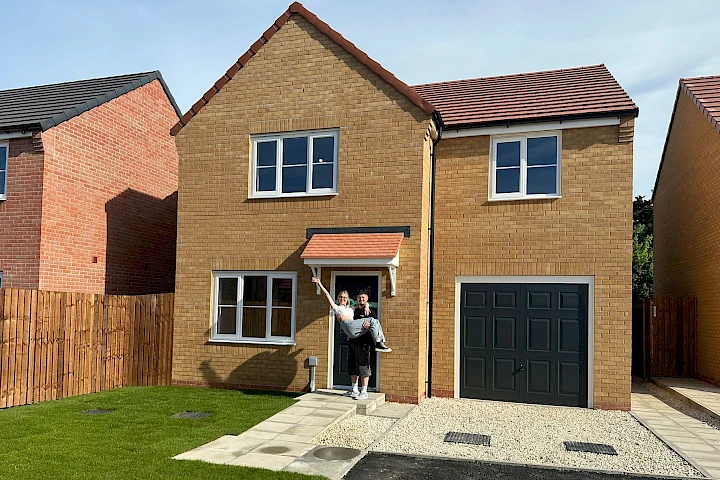Couple at the front of their house
