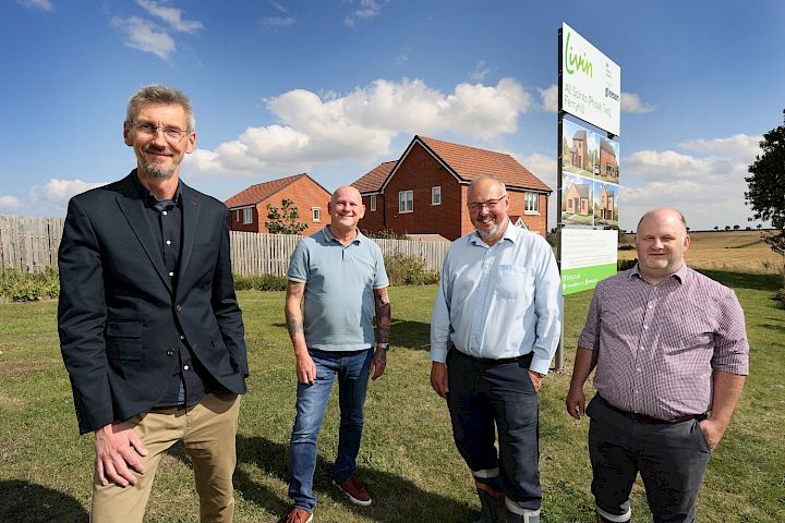 Gleeson and Living Housing team stood outside the entrance of Gleeson's All Saints development