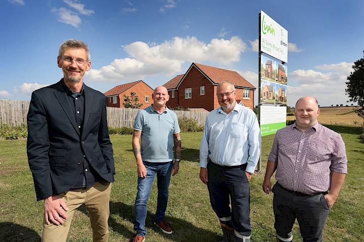 Gleeson and Living Housing team stood outside the entrance of Gleeson's All Saints development