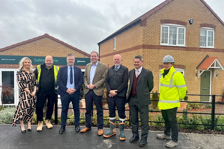 Colleagues and Charlie Dewhurst MP standing outside of a Gleeson sales centre