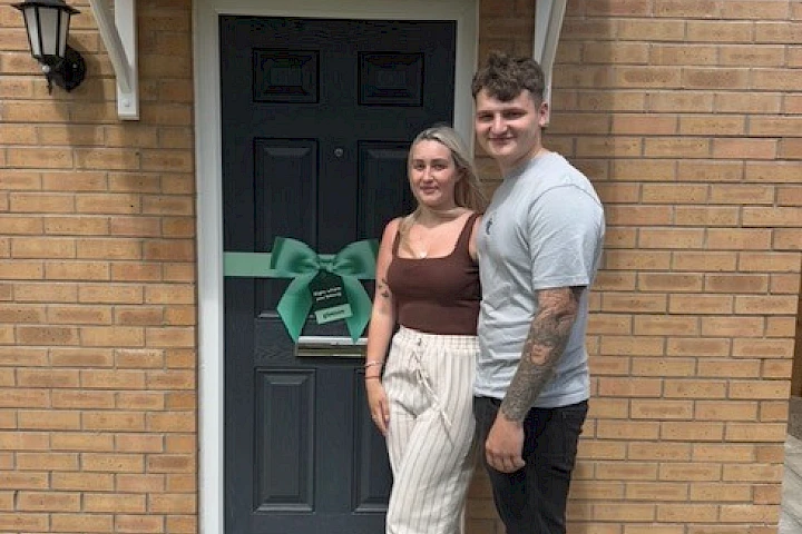 Couple stood outside their house