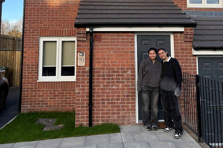 Couple stood at the front of the house