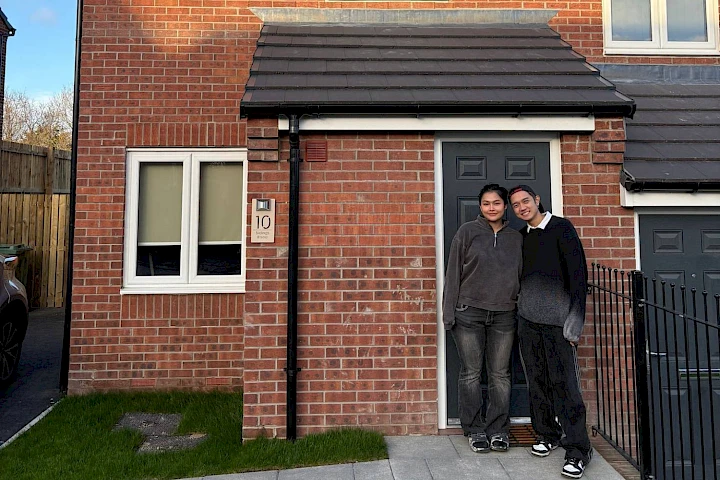 Couple stood at the front of the house