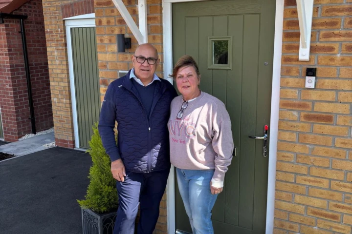 Couple at the front of their house
