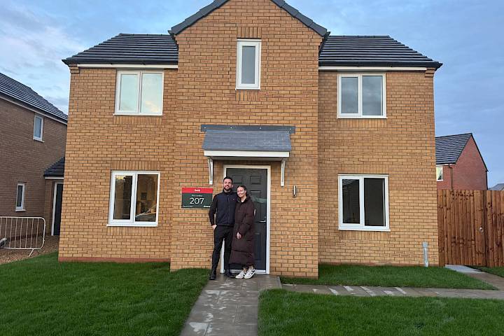 Couple stood at the front of their home