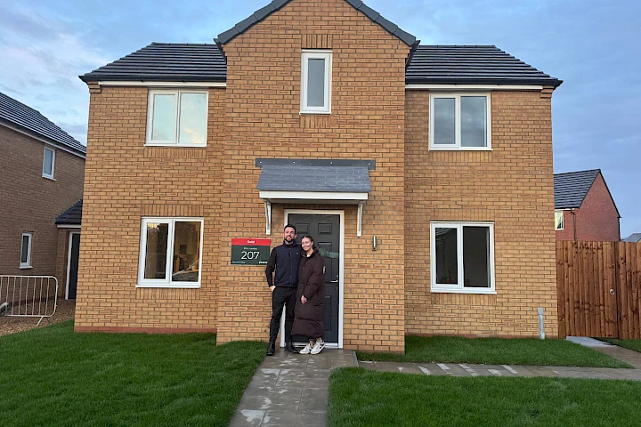 Couple stood at the front of their home