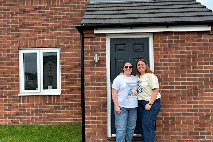 Couple stood outside their home