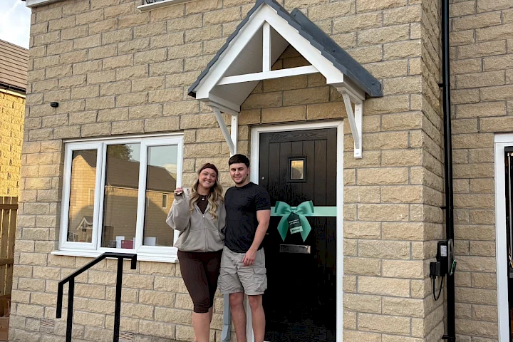 Couple at the front of their house